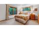 Cozy bedroom with natural light and views of the landscaped surroundings at 2775 Crabapple Rd, Golden, CO 80401