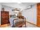 View of bedroom with wooden furnishings, single bed, and a decorative shelf with collectable items at 2775 Crabapple Rd, Golden, CO 80401