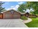 Home exterior featuring a brick and siding facade, well manicured lawn and a two car garage at 2775 Crabapple Rd, Golden, CO 80401