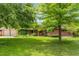 Charming ranch-style home with mature trees, lush lawn and flowerbeds in the front yard at 2775 Crabapple Rd, Golden, CO 80401
