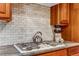Close-up of stove and countertop area with subway tile backsplash at 2775 Crabapple Rd, Golden, CO 80401