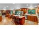 Open concept kitchen featuring an island, stainless appliances, and hardwood floors at 2775 Crabapple Rd, Golden, CO 80401