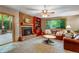Cozy living room with a brick fireplace, built-in shelving, and comfortable seating at 2775 Crabapple Rd, Golden, CO 80401