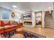Finished basement living room with fireplace, TV, and leather sofa at 2775 Crabapple Rd, Golden, CO 80401