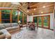 Bright sunroom with wood-paneled ceiling, large windows, and comfortable seating area at 2775 Crabapple Rd, Golden, CO 80401