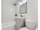 Clean bathroom with a gray vanity and white tiled walls at 1616 Oakland St, Aurora, CO 80010