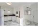 Modern dining area with marble floors and kitchen access at 1616 Oakland St, Aurora, CO 80010