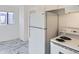 Kitchen with white appliances and marble floors at 1616 Oakland St, Aurora, CO 80010