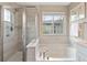 Bathroom showcasing a separate shower and soaking tub at 239 W Jamison Ct, Littleton, CO 80120