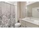 A clean bathroom is fitted with a shower-tub combination and a stylish vanity with countertop space at 239 W Jamison Ct, Littleton, CO 80120