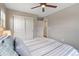 Neutral bedroom with a striped coverlet and a ceiling fan at 239 W Jamison Ct, Littleton, CO 80120