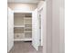 An organized closet with open doors shows shelving and ample storage space for an efficient wardrobe at 239 W Jamison Ct, Littleton, CO 80120