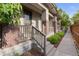 Charming front porch featuring brick accents, concrete steps, and a wooden railing at 239 W Jamison Ct, Littleton, CO 80120