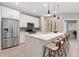 Bright kitchen with stainless steel appliances, white cabinets, and counter seating at 239 W Jamison Ct, Littleton, CO 80120