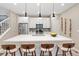 Modern kitchen featuring white cabinetry, stainless steel appliances, and a large island at 239 W Jamison Ct, Littleton, CO 80120