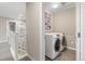 Upstairs laundry room with side-by-side washer and dryer at 239 W Jamison Ct, Littleton, CO 80120