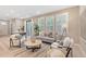 Open-concept living room featuring neutral tones, natural light, and contemporary furnishings at 239 W Jamison Ct, Littleton, CO 80120