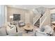 Cozy living room with staircase, contemporary decor, and an open layout at 239 W Jamison Ct, Littleton, CO 80120