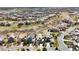 An aerial view showcasing homes with solar panels, landscaping, and neighborhood street layout at 10492 Willowwisp Way, Highlands Ranch, CO 80126