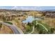 Panoramic aerial view showcasing a pond with walking paths winding through a residential area at 10492 Willowwisp Way, Highlands Ranch, CO 80126