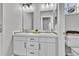 Bright bathroom with a double vanity featuring modern fixtures, mosaic tile, and white cabinetry at 10492 Willowwisp Way, Highlands Ranch, CO 80126