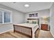 Cozy bedroom with a wood-framed bed, soft lighting, and a window offering a peaceful and inviting atmosphere at 10492 Willowwisp Way, Highlands Ranch, CO 80126