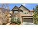 Charming two-story home featuring stone accents, an attached garage, and a well-manicured front yard at 10492 Willowwisp Way, Highlands Ranch, CO 80126