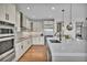Bright kitchen features stainless appliances, a marble countertop island, and wooden floors at 10492 Willowwisp Way, Highlands Ranch, CO 80126