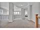 Open loft area with neutral carpet, decorative railing and ample natural light at 10492 Willowwisp Way, Highlands Ranch, CO 80126