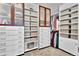 Spacious walk-in closet with custom shelving, drawers, cabinets, and ample storage for clothes and accessories at 10492 Willowwisp Way, Highlands Ranch, CO 80126
