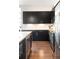 Contemporary kitchen boasts black cabinets, stainless appliances, and granite countertops with sleek backsplash at 336 E 1St Ave # 209, Denver, CO 80203