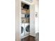 Laundry closet with a stacked washer and dryer, and shelving for storage at 336 E 1St Ave # 209, Denver, CO 80203