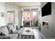 Cozy living room with comfortable sofa, fireplace and large window with access to outdoor seating area at 336 E 1St Ave # 209, Denver, CO 80203