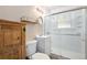Compact bathroom with a white tile shower, modern vanity, and rustic wood accents, offering a clean design at 1979 Beeler St, Aurora, CO 80010