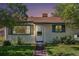 Charming single-story home featuring a well-maintained lawn, green shutters, and classic siding under a brown roof at 1979 Beeler St, Aurora, CO 80010