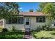 Charming single-story home featuring a well-maintained lawn, green shutters, and classic siding under a brown roof at 1979 Beeler St, Aurora, CO 80010