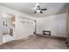 Open living area with neutral carpet, open shelving, and a view into the kitchen, creating a bright and airy space at 1979 Beeler St, Aurora, CO 80010