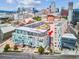 Aerial view of the building highlighting the unit location with a red arrow and the cityscape in the background at 55 W 12Th Ave # 512, Denver, CO 80204