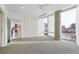 Bright bedroom featuring carpet flooring, a large window, and a view of the cityscape beyond the window at 55 W 12Th Ave # 512, Denver, CO 80204