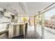Modern kitchen featuring stainless steel island, high-end appliances, and floor-to-ceiling windows with city views at 55 W 12Th Ave # 512, Denver, CO 80204