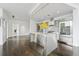 Open-concept kitchen with stainless steel appliances, center island, and hardwood floors, leading to an open living space at 55 W 12Th Ave # 512, Denver, CO 80204