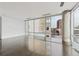Spacious and bright living room with hardwood floors and large windows offering cityscape views at 55 W 12Th Ave # 512, Denver, CO 80204
