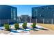 A rooftop deck with modern green Adirondack chairs at 55 W 12Th Ave # 512, Denver, CO 80204
