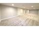 Large finished basement with new carpet, neutral paint, recessed lighting, and access to stairs at 2274 S Newton St, Denver, CO 80219