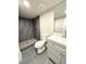 Modern bathroom featuring gray tile shower, updated vanity, fixtures and finishes at 2274 S Newton St, Denver, CO 80219
