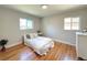 Cozy bedroom featuring hardwood floors, neutral paint, and large windows for plenty of natural light at 2274 S Newton St, Denver, CO 80219