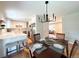 Dining area with an adjacent modern kitchen, hardwood floors, and a dining room table set for four at 2274 S Newton St, Denver, CO 80219