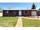 Charming single story home with a manicured lawn, inviting entryway, and beautiful exterior paint scheme at 2274 S Newton St, Denver, CO 80219