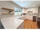 Bright kitchen with quartz countertops, stainless steel appliances, hardwood floors, and ample storage space at 2274 S Newton St, Denver, CO 80219