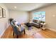 Cozy living room with lots of natural light, hardwood floors, neutral paint, and a stylish and comfortable seating area at 2274 S Newton St, Denver, CO 80219
